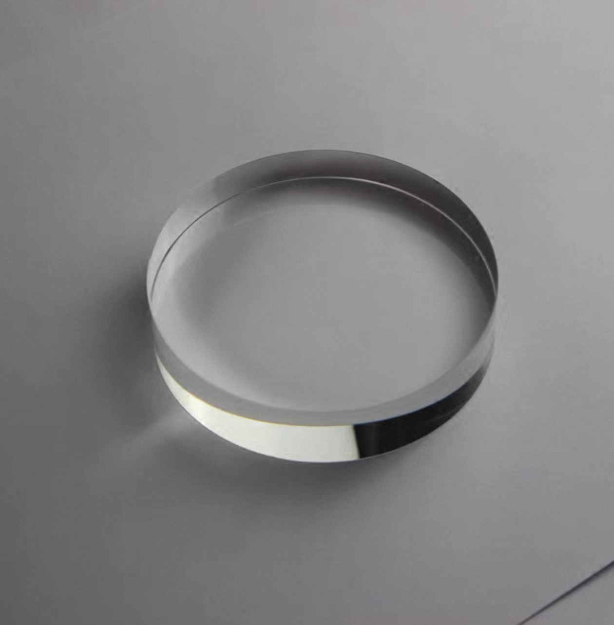 A set of clear circular K9 optical crystal blanks with polished edges for 3D laser engraving.